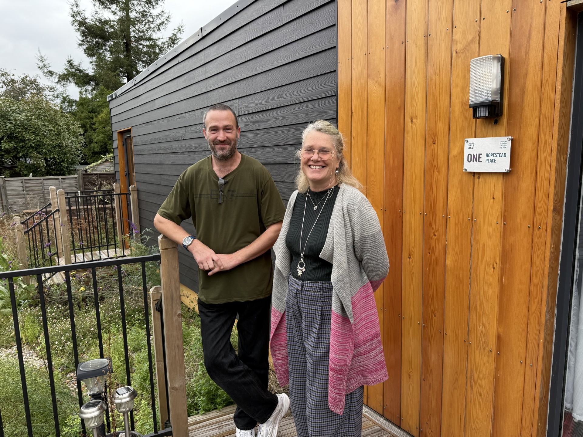 People smiling on front porch