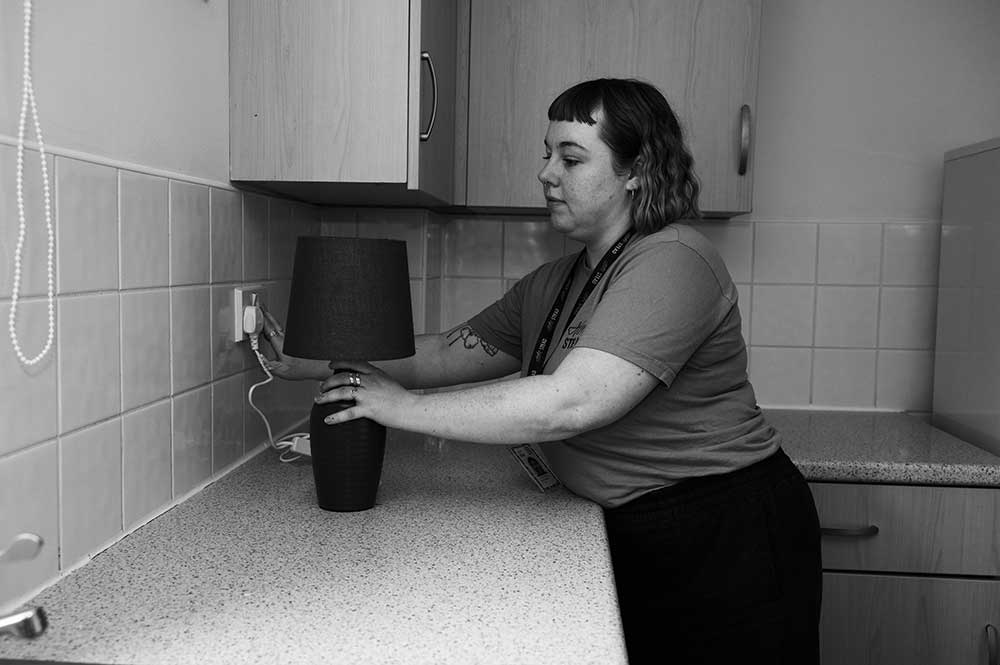 Person plugging in a lamp